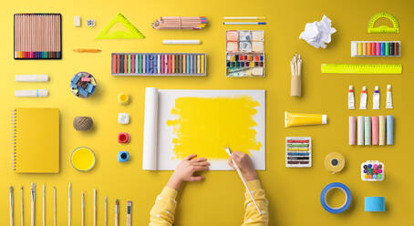 A flat lay top view of child hands with school supplies, back to school concept. - HPIF06451