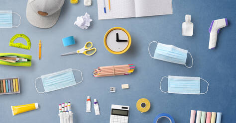 A flat lay top view of face mask and school supplies, back to school and coronavirus concept. - HPIF06460