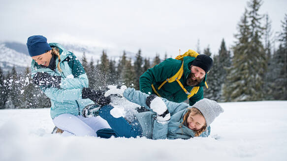 Familie mit kleiner Tochter, die sich in der winterlichen Natur des Tatra-Gebirges in der Slowakei vergnügt. - HPIF06571