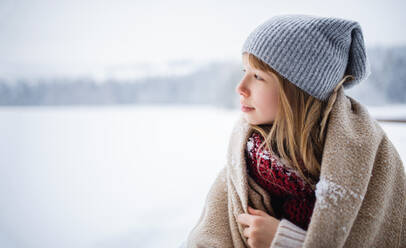 A portrait of preteen girl outdoors in winter nature, copy space. - HPIF06630