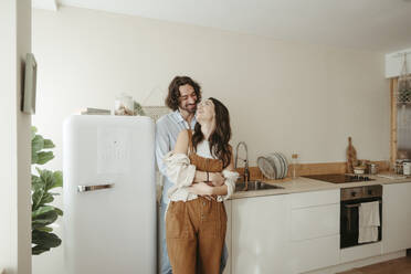 Affectionate couple standing with arm around at home - RCPF01704