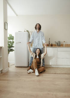 Happy couple having fun in kitchen at home - RCPF01707