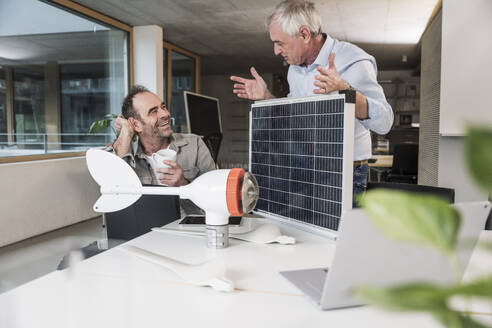 Business colleagues discussing together at office - UUF28283