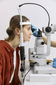 Patient doing vision diagnostics exam at medical clinic - SANF00047