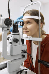 Woman undergoing vision diagnostics test at medical clinic - SANF00048