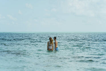 Couple standing in sea on vacation - IEF00308