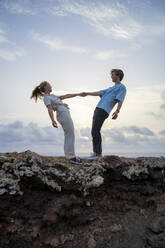 Boyfriend and girlfriend enjoying with each other on mountain - FBAF02116