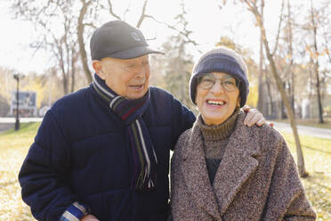 Happy senior couple enjoying together at autumn park - SEAF01755