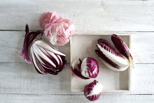 Raw radicchio lying on white wooden surface - ASF06850