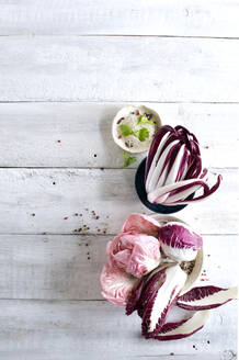 Raw radicchio lying on white wooden surface - ASF06854