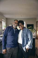 Portrait of smiling senior couple standing with each other at home - MASF36066