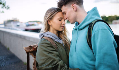 A happy young couple travelers in love in city on holiday, hugging. - HPIF07315