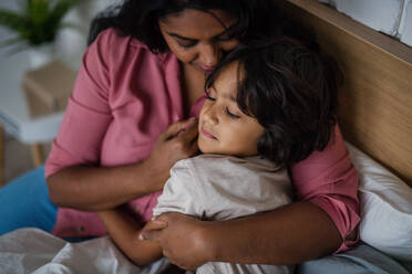 A close-up of indian mother hugging her little son at home. - HPIF07319