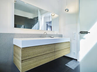 Bathroom with mirror on wall in apartment - RORF03414