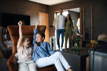 A happy two sisters with parents enjoying time at luxury hotel, summer holiday. - HPIF07641