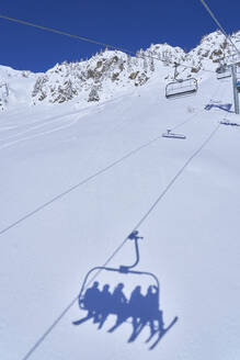 Shadow of ski lift on snowcapped mountain - JAHF00207