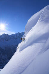 Mature woman skiing on snowcapped mountain - JAHF00209