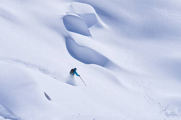 Mature man skiing on slope in snow - JAHF00212