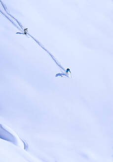 Man and woman skiing in snow - JAHF00232