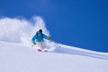 Man skiing on snow covered mountain - JAHF00263