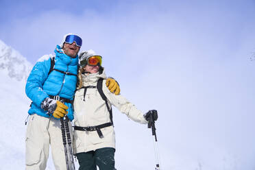 Happy couple with arm around on sunny day - JAHF00270