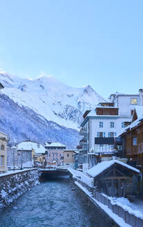 Canal amidst buildings in front of mountains - JAHF00328