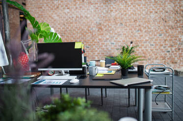 Desks with computers and other office supplies, a coworking concept. - HPIF08005