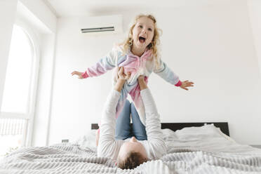 Happy daughter having fun and playing with father at home - SIF00676