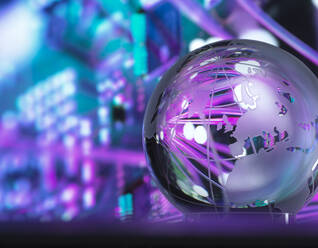 Crystal globe with fibre optics processing data in background - ABRF01067