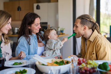 A happy multigeneration family indoors at home eating healthy lunch. - HPIF08551
