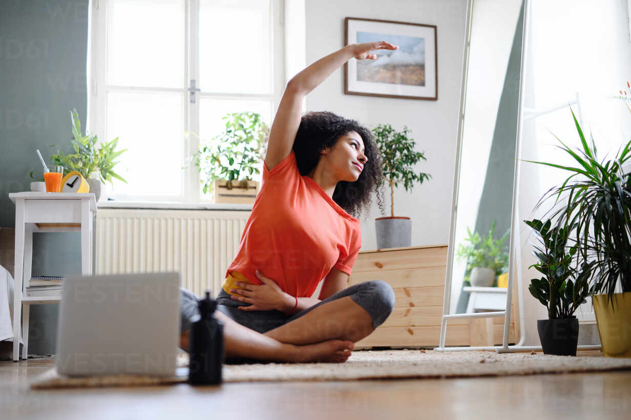 Fitness, yoga and gym at home concept. Young woman doing