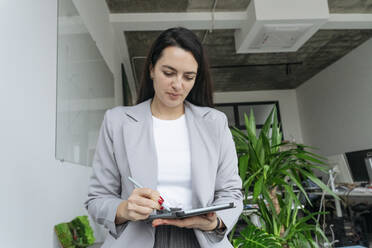 Businesswoman using tablet PC at workplace - OSF01430