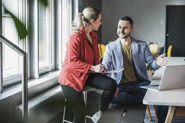 Businessman planning strategy with colleague at office - UUF28366