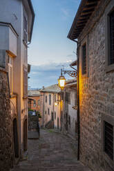 Illuminated alley amidst buildings at sunset - MAMF02622