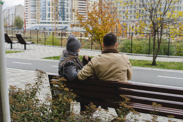 Man and woman sitting on bench - SEAF01813