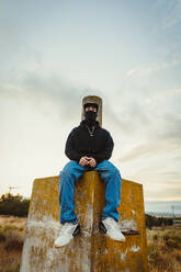 Boy with balaclava sitting while looking at the camera - CAVF96596