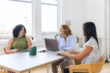 Multiracial business colleagues discussing strategy in office stdio - CAVF96631