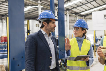 Engineers having discussion in factory - JCCMF09696