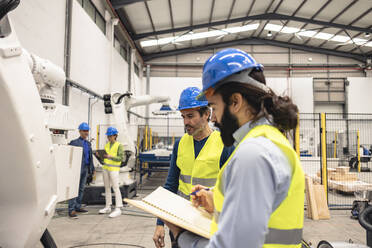 Ingenieure arbeiten in einer Roboterfabrik - JCCMF09848