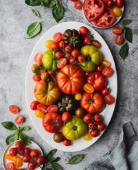 Top view of platter of colorful heirloom and cherry tomatoes. - CAVF96767