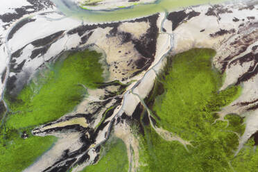 Aerial view of river canals, resembling a tree and branches, in a marshland part of the estuary of river Vouga, in Ria de Aveiro, Aveiro, Portugal. - AAEF17369