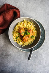 From above bowl with pasta and meatballs on concrete table background - ADSF43270