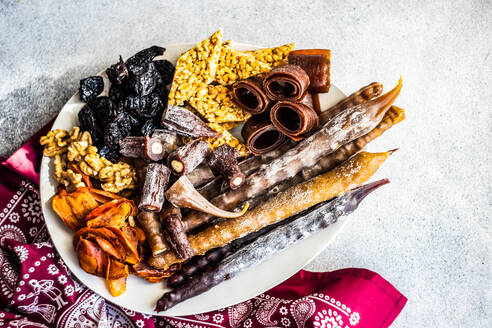 From above traditional georgian dessert set with dried fruits, nuts, and churchkhela - ADSF43279