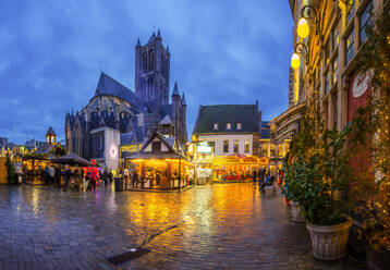 Ghent Christmas market with glowing lights in evening town near old buildings and tramway track - ADSF43405