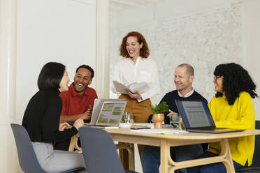 Happy business people having fun sitting in meeting room - EBSF02980