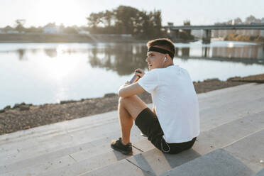 Man sitting on steps after exercising - ANNF00094