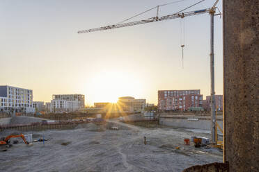 Construction site with buildings and crane at sunset - MAMF02653