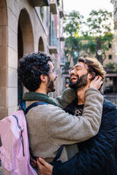 Happy gay men embracing and laughing together - GDBF00059