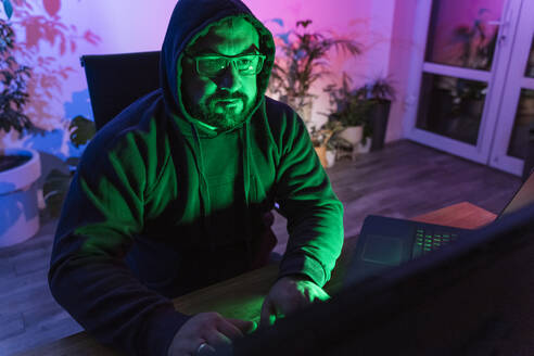 Hacker using laptop at home - OSF01467