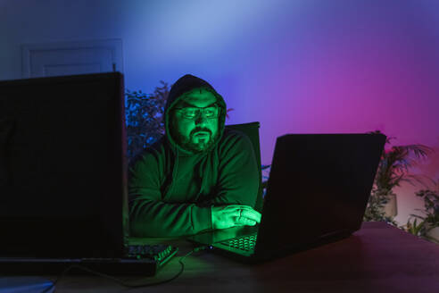 Hacker with computers on desk at home - OSF01468